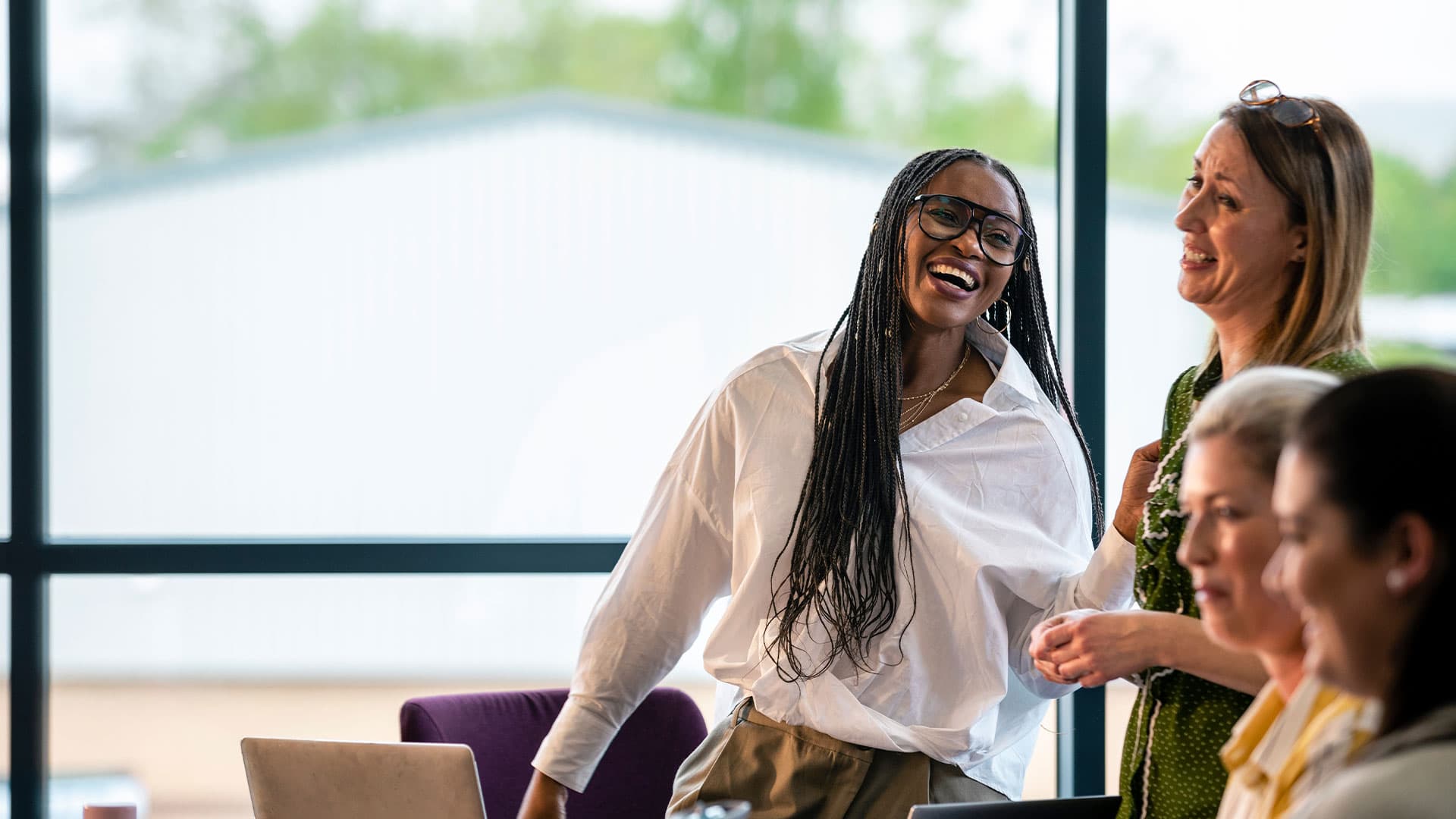 Two women engaged in conversation in an office setting