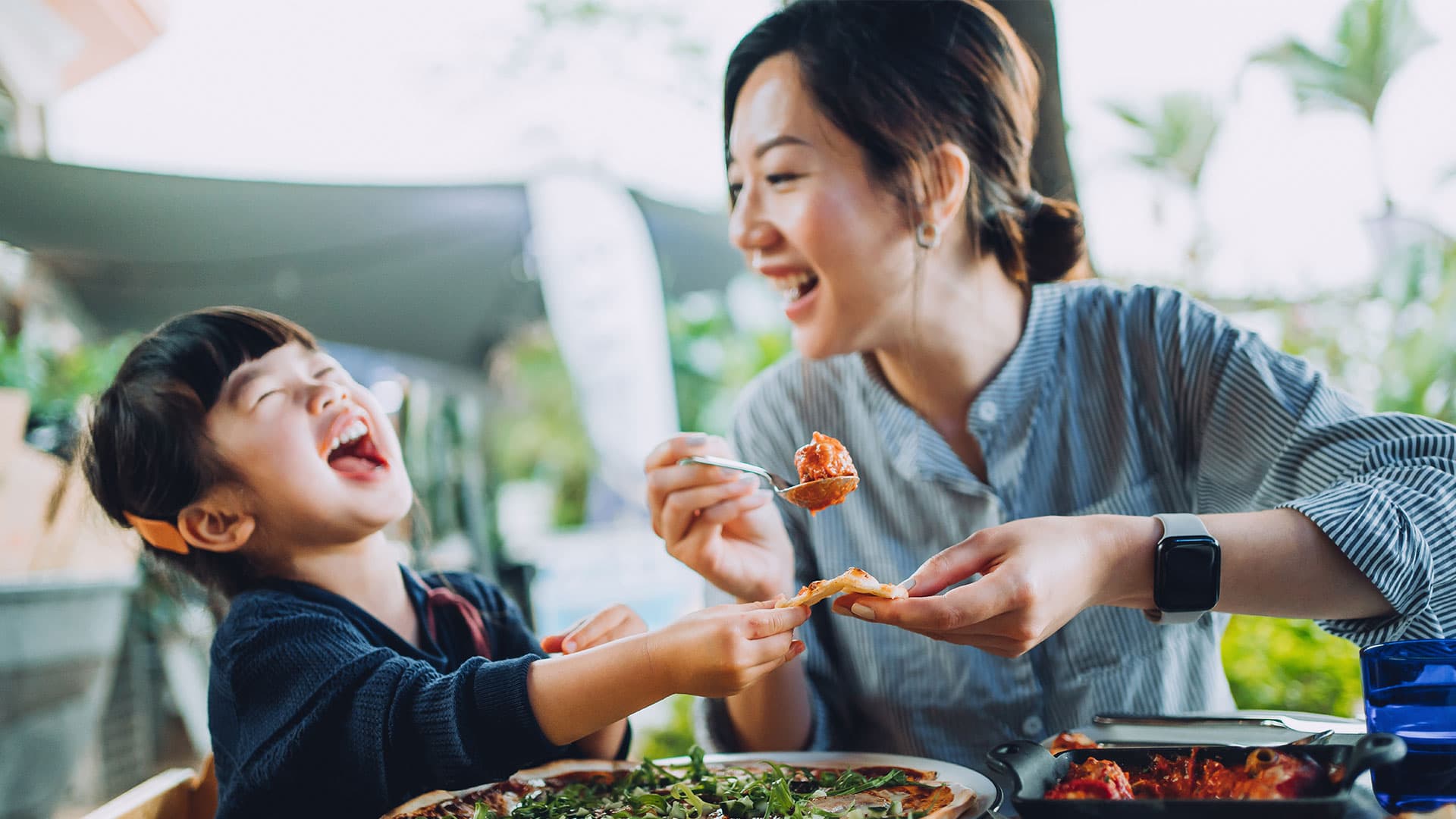 Parent and child eating and laughing